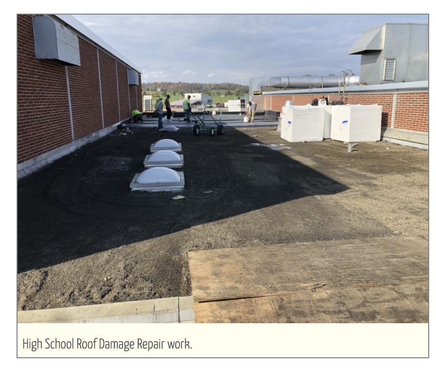 High school roof damage repair work. 